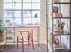 Close-up view of a home office, showcasing a wooden desk, red chair, and stylish bookshelf at 19 Sangre De Cristo Dr, Durham, NC 27705