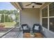 Relaxing screened-in patio with wicker chairs, a wooden table, and views of the landscaped backyard at 19 Sangre De Cristo Dr, Durham, NC 27705