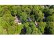 Expansive aerial view showcases the home nestled within a dense canopy of mature trees at 202 Homestead Dr, Cary, NC 27513