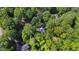 Aerial view of the home nestled among lush trees in a quiet neighborhood, offering a sense of privacy and tranquility at 202 Homestead Dr, Cary, NC 27513