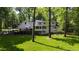 Expansive backyard view showcasing the home's deck, patio, and lush landscaping, offering a private outdoor space at 202 Homestead Dr, Cary, NC 27513
