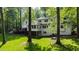 Lush backyard featuring a well-maintained lawn, mature trees, and a deck, creating a serene outdoor setting at 202 Homestead Dr, Cary, NC 27513
