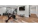 Basement fitness area with modern exercise equipment, a large television, and neutral paint at 202 Homestead Dr, Cary, NC 27513