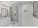 Contemporary bathroom featuring a glass enclosed shower, granite countertops and modern tiling at 202 Homestead Dr, Cary, NC 27513