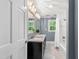 Renovated bathroom features a dual sink vanity, tub and shower with white tile and marble floors at 202 Homestead Dr, Cary, NC 27513