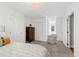Cozy bedroom featuring neutral walls, carpet, a tall wood dresser and an inviting chair at 202 Homestead Dr, Cary, NC 27513