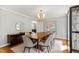 Elegant dining room with a wood table, modern buffet, and gold light fixture at 202 Homestead Dr, Cary, NC 27513