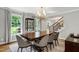 Inviting dining room showcasing a large table, modern chandelier, and bright windows at 202 Homestead Dr, Cary, NC 27513