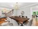 Bright dining room featuring a large table, staircase and light fixture at 202 Homestead Dr, Cary, NC 27513
