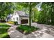 Side view showing a paved driveway and attached garage surrounded by green trees at 202 Homestead Dr, Cary, NC 27513