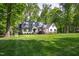 Charming home with mature trees, beautiful lawn, and attractive landscaping at 202 Homestead Dr, Cary, NC 27513