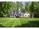 Charming white-painted home with a manicured lawn and mature trees at 202 Homestead Dr, Cary, NC 27513