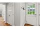 Hallway features wood floor and front door with nature views and convenient coat rack at 202 Homestead Dr, Cary, NC 27513