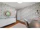 Cozy home office featuring patterned wallpaper, hardwood flooring, and modern decor at 202 Homestead Dr, Cary, NC 27513
