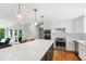 Bright kitchen with quartz counters, an expansive island, and contemporary finishes at 202 Homestead Dr, Cary, NC 27513