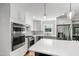 Well-equipped kitchen with stainless appliances, backsplash, and a large island at 202 Homestead Dr, Cary, NC 27513