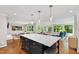 Bright, open kitchen with large island, quartz countertops, and modern pendant lighting at 202 Homestead Dr, Cary, NC 27513