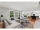 Spacious living room with comfortable seating, large windows, and open floor plan at 202 Homestead Dr, Cary, NC 27513