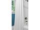 Bright shower with white tile, a window, and stylish fixtures at 202 Homestead Dr, Cary, NC 27513
