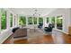 Charming sunroom with ample windows, cozy seating, and wooded views at 202 Homestead Dr, Cary, NC 27513