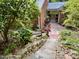 Picturesque backyard with stone steps, brick pathway, lush greenery, and mature trees at 204 N Elliott Rd, Chapel Hill, NC 27514