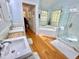 Bright bathroom with double sinks, a soaking tub, and a glass-enclosed shower, offering a spa-like experience at 204 N Elliott Rd, Chapel Hill, NC 27514