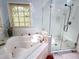 Luxurious bathroom with a jacuzzi tub and a separate glass shower, designed for relaxation and comfort at 204 N Elliott Rd, Chapel Hill, NC 27514
