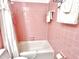 Bathroom featuring a pink tile bathtub-shower combination and classic, retro fixtures at 204 N Elliott Rd, Chapel Hill, NC 27514