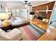 Inviting bedroom features a brick fireplace, colorful rug, and a comfortable bed, offering a relaxing space at 204 N Elliott Rd, Chapel Hill, NC 27514