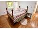Bedroom with wooden floors, a four-poster bed, and great light from large windows at 204 N Elliott Rd, Chapel Hill, NC 27514