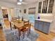 Cozy dining area with a wooden table, blue cabinets, and stylish decor, flowing into living spaces at 204 N Elliott Rd, Chapel Hill, NC 27514