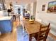 Bright dining area with a wooden table, open to the kitchen, featuring a skylight and modern appliances at 204 N Elliott Rd, Chapel Hill, NC 27514