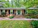 Home featuring a classic brick facade, black shutters, and beautiful brick entrance at 204 N Elliott Rd, Chapel Hill, NC 27514