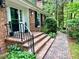 Home's front entrance with brick steps and iron railing leads to a landscaped pathway at 204 N Elliott Rd, Chapel Hill, NC 27514