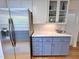 Modern kitchen with stainless steel appliances, light blue cabinets, and white countertops at 204 N Elliott Rd, Chapel Hill, NC 27514