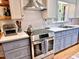 Updated kitchen features stainless steel appliances, light blue cabinets, and white subway tile backsplash at 204 N Elliott Rd, Chapel Hill, NC 27514