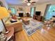 Spacious living room with hardwood floors, ceiling fan, fireplace, and natural light at 204 N Elliott Rd, Chapel Hill, NC 27514