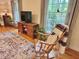 Inviting living room featuring a comfortable rocking chair, a stylish rug, and natural light at 204 N Elliott Rd, Chapel Hill, NC 27514