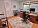 Bright office space with hardwood floors, large desk, shelving, and modern furnishings at 204 N Elliott Rd, Chapel Hill, NC 27514