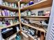 Organized walk-in pantry featuring wooden shelving and ample storage space for various kitchen items and supplies at 204 N Elliott Rd, Chapel Hill, NC 27514