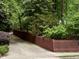 Street view showcases a brick home behind a brown picket fence and lush greenery at 204 N Elliott Rd, Chapel Hill, NC 27514
