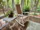 Comfortable sunroom featuring brick floors, floor-to-ceiling windows, and a relaxing rocking chair at 204 N Elliott Rd, Chapel Hill, NC 27514