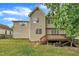 Backyard view features a wood deck and verdant lawn for outdoor enjoyment at 206 Wagon Trail Dr, Cary, NC 27513