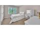 Bright bedroom featuring a bed, vanity and a window with lush green outdoor views at 206 Wagon Trail Dr, Cary, NC 27513