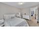 Light and bright bedroom with neutral walls, carpet, a white bed and white furnishings at 206 Wagon Trail Dr, Cary, NC 27513