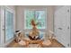 Bright breakfast nook features a glass table, wood chairs, and a view of the backyard at 206 Wagon Trail Dr, Cary, NC 27513