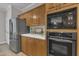 Kitchen features stainless steel refrigerator, built in microwave and oven and light wood cabinets with white countertops at 206 Wagon Trail Dr, Cary, NC 27513