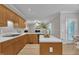 Charming kitchen boasts a functional layout with light wood cabinets, modern appliances, and connection to a dining area at 206 Wagon Trail Dr, Cary, NC 27513