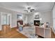 Inviting living room features a cozy fireplace, ceiling fan, and neutral decor, perfect for relaxation and gatherings at 206 Wagon Trail Dr, Cary, NC 27513