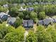 Aerial view of a landscaped home surrounded by lush greenery in a well-maintained neighborhood at 209 Brookberry Rd, Holly Springs, NC 27540